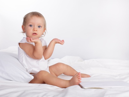 Beautiful baby in bedの写真素材