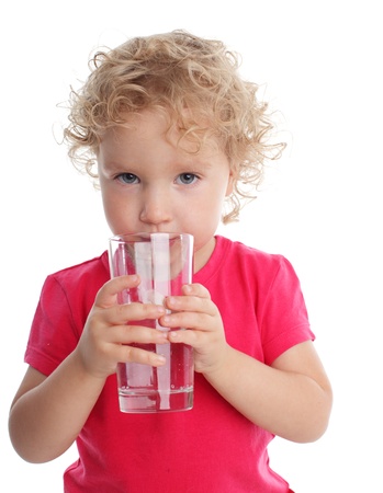 Littl girl with a water glassの写真素材