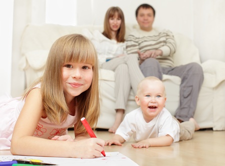 Happy family with two children at homeの写真素材