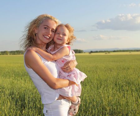 Happy mother with daughter outdoorsの写真素材
