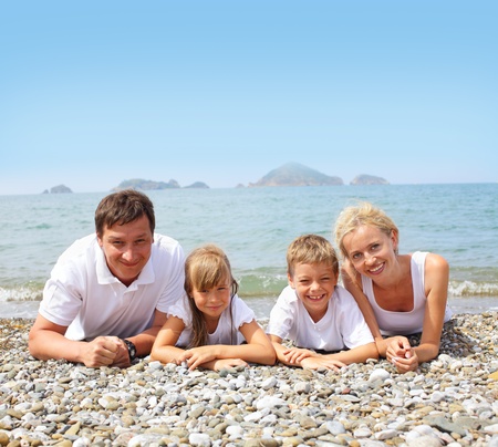 Happy family on the beachの写真素材