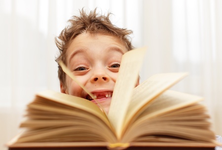 Little happy boy with bookの写真素材