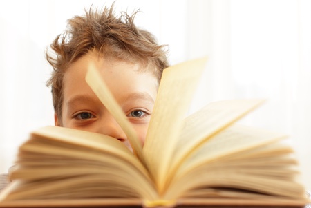 Little happy boy with book