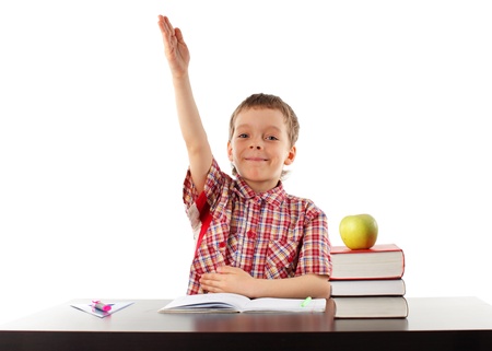 Happy schoolboy behind a school deskの写真素材