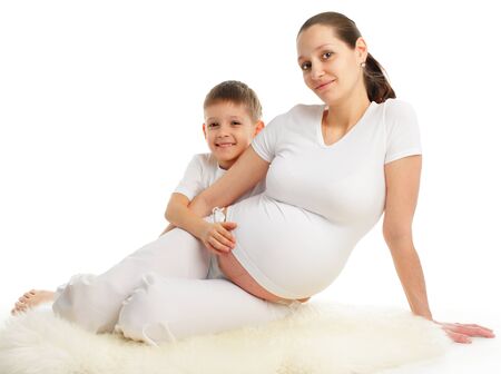 Pregnant woman with the son isolated on whiteの写真素材