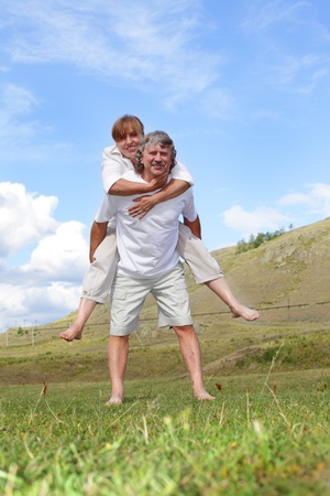 Happy adult couple outdoorsの写真素材