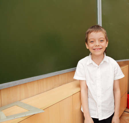 Happy schoolboy before a boardの写真素材