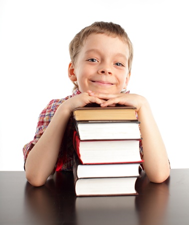 Schoolboy with books isolated on whiteの写真素材