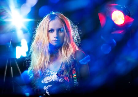 Beautiful young woman under the light flashes