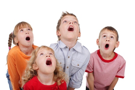 Surprised by children looking up isolated on whiteの写真素材