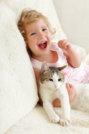 Little happy girl with a catの写真素材