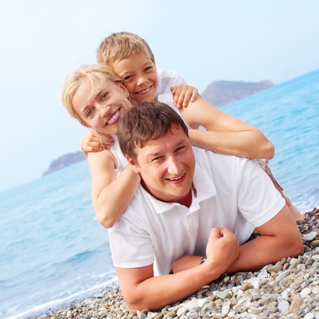 Happy family on the beachの写真素材