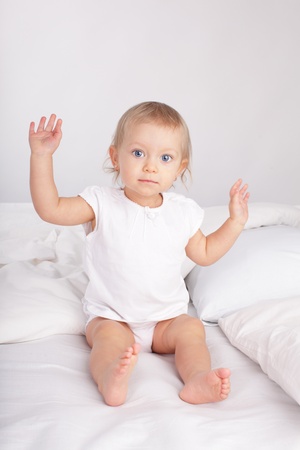 Beautiful baby in bedの写真素材