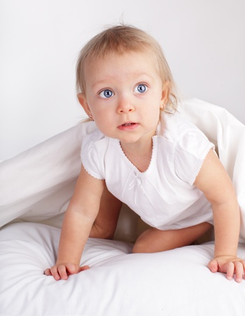 Beautiful baby in bedの写真素材