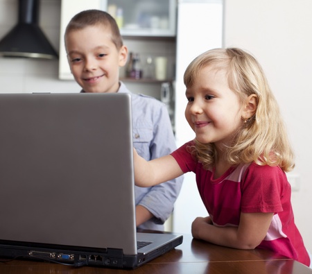 Children with laptop at homeの写真素材