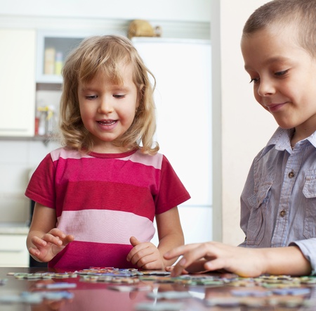 Child, playing puzzles at homeの写真素材