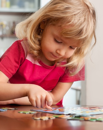 Child, playing puzzles at homeの写真素材
