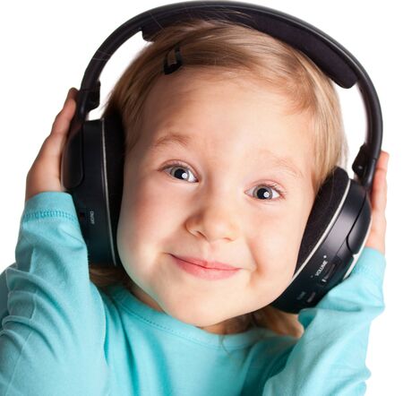 Little child in headphones isolated on whiteの写真素材