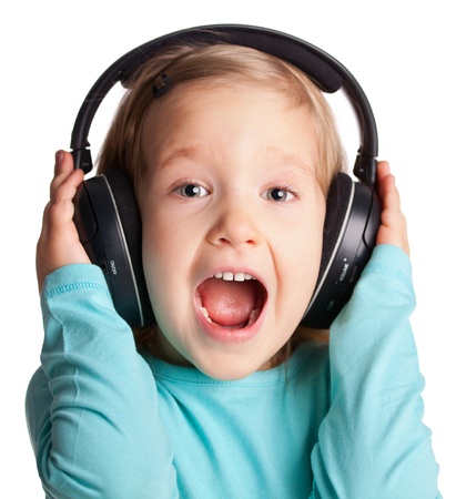 Singing child in headphones isolated on whiteの写真素材