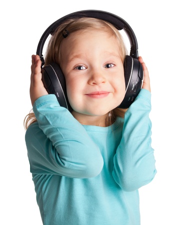 Little child in headphones isolated on whiteの写真素材