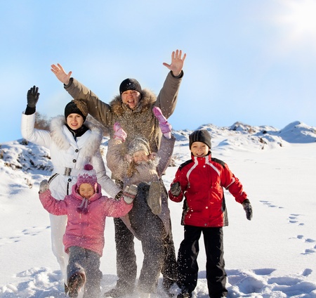 Family with children in the snow in winter.の写真素材