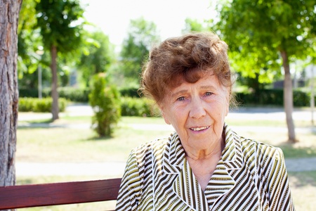 Old woman in park. Happy senior woman.の写真素材