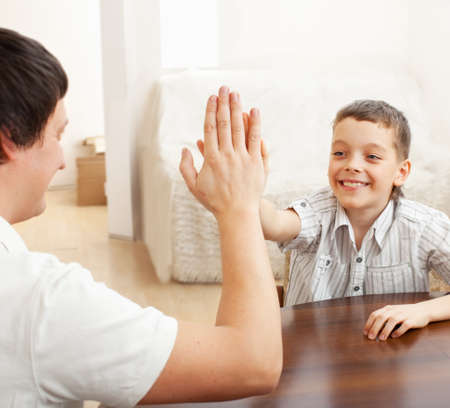 Happy father with son at homeの写真素材