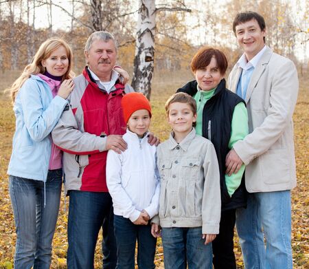 Families with children and grandparents in autumn park