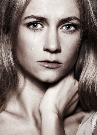 Sad woman with tears in her eyesの写真素材