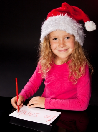 Child writing a letter to santa claus. Little girlの写真素材