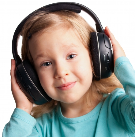 Little child in headphones isolated on whiteの写真素材