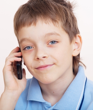 Child, talking on the mobile phoneの写真素材