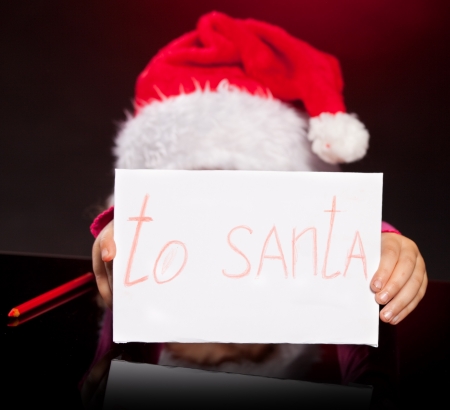 Child writing a letter to santa claus. Dreams little girl'sの写真素材
