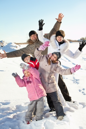 Family with children on snow in winterの写真素材