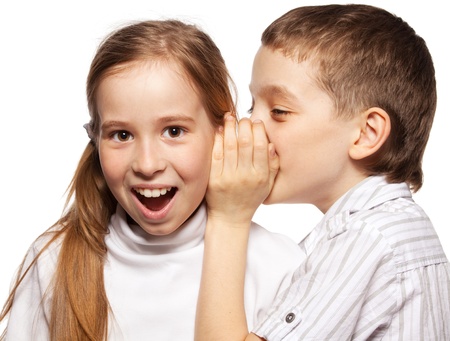 Boy whispers girl in the ear secret. Childrens gossipの写真素材