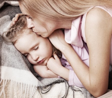 Parent touching forehead sleeping child. Illness childの写真素材