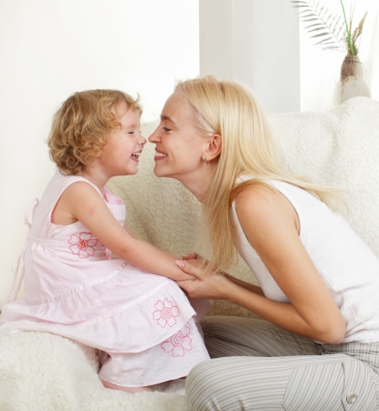 Happy mother with a daughter at homeの写真素材