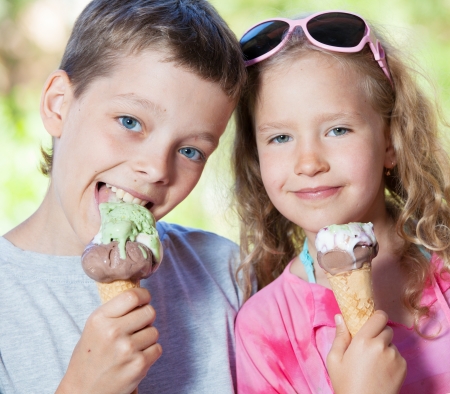 Happy children with ice cream outdoorsの写真素材