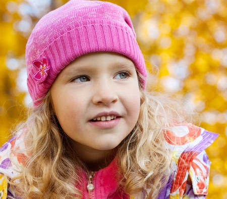 Little happy girl in autumn parkの写真素材