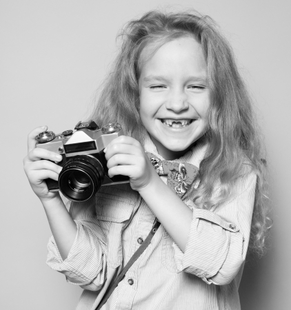 Child with camera. Little girl photographingの写真素材