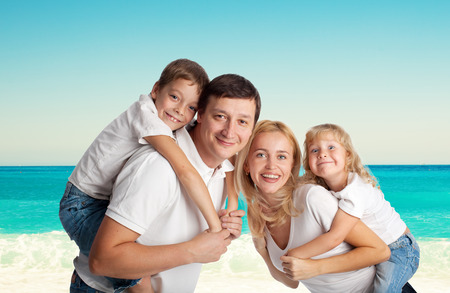 Family with two children on the beachの写真素材