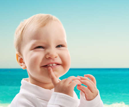 Happy little girl at the beachの写真素材