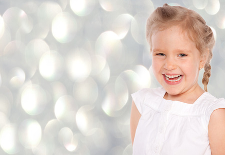 Little girl at gray background. Happy childの写真素材