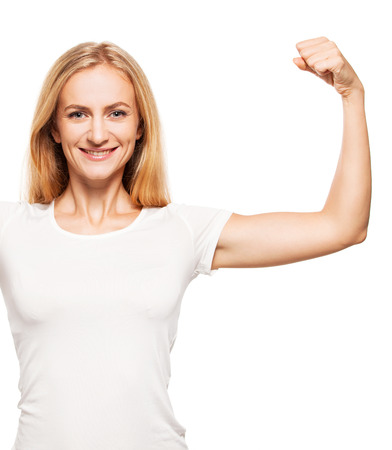 Strong woman. Female showing bicepsの写真素材