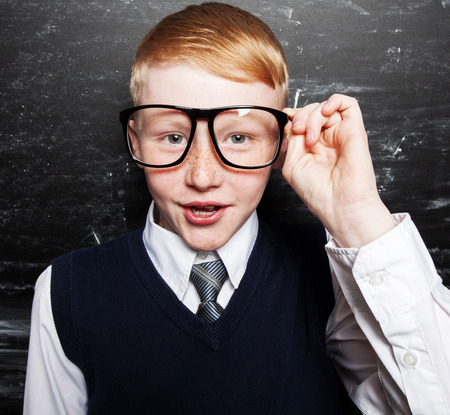 Boy near blackboard. Child at school. Student at classroom
