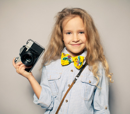 Child with camera. Little girl photographingの写真素材
