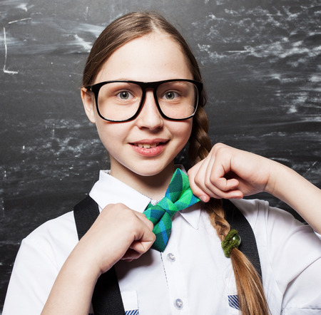 Girl near blackboard. Child at school. Student at classroomの写真素材