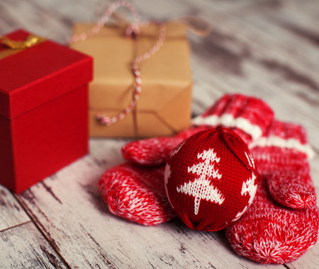 Mitten with christmas ball on wood floor. Winter decorationの写真素材