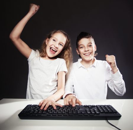 Children looking at a computer. fortune, winの写真素材