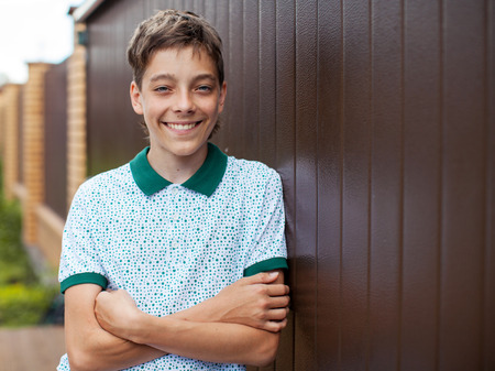 Smiling teen outdoors at summer. Happy one boyの写真素材